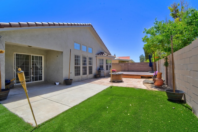 9811 Saragossa St NW, Albuquerque, NM 87114 - rear view of house with a fenced backyard, stucco siding, a lawn, and a patio area