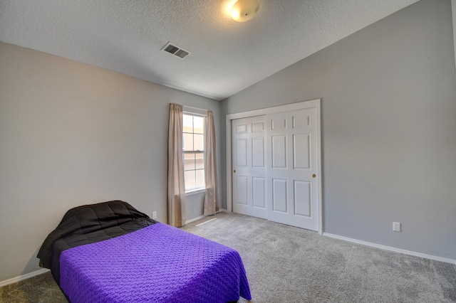 9811 Saragossa St NW, Albuquerque, NM 87114 - carpeted bedroom with a textured ceiling, baseboards, lofted ceiling, visible vents, and a closet