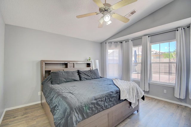 9811 Saragossa St NW, Albuquerque, NM 87114 - bedroom featuring visible vents, wood finished floors, baseboards, a ceiling fan, and vaulted ceiling