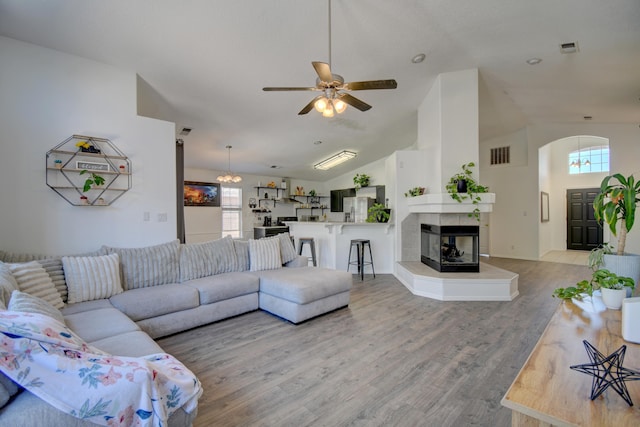 9811 Saragossa St NW, Albuquerque, NM 87114 - living area featuring ceiling fan, visible vents, arched walkways, vaulted ceiling, and light wood-style floors