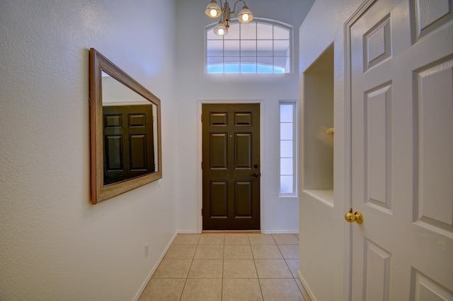 9811 Saragossa St NW, Albuquerque, NM 87114 - entrance foyer featuring light tile patterned floors, baseboards, and a notable chandelier
