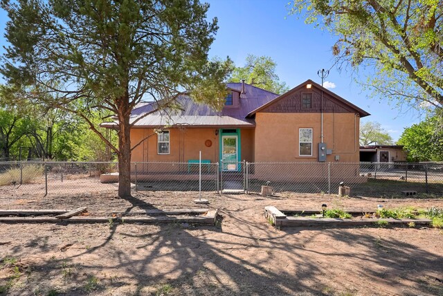 11009 Edith Blvd NE, Albuquerque, NM 87113 - view of front of home featuring metal roof, fence private yard, and stucco siding
