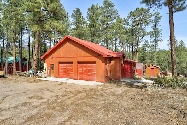 detached garage featuring a storage unit