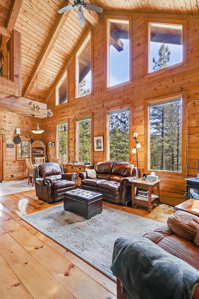 living area with high vaulted ceiling, wooden ceiling, and a wealth of natural light