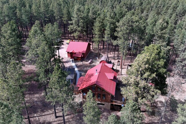 drone / aerial view featuring a forest view