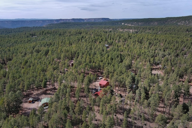 birds eye view of property featuring a view of trees