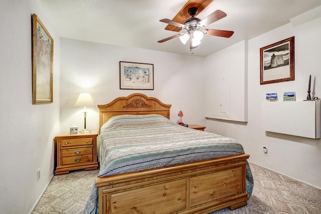 carpeted bedroom featuring baseboards and ceiling fan