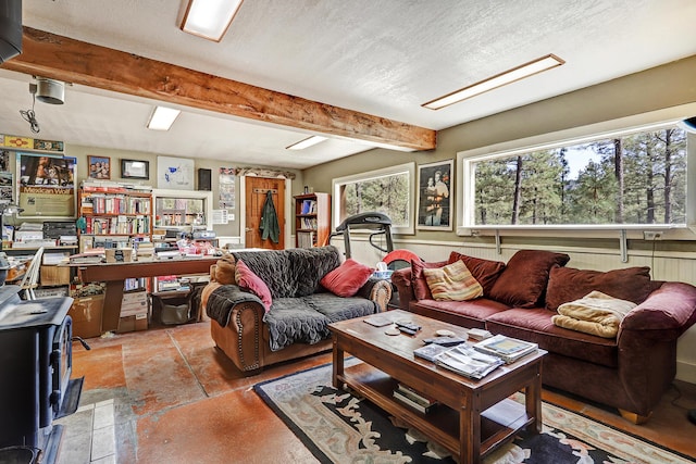 living area featuring a wood stove and beam ceiling