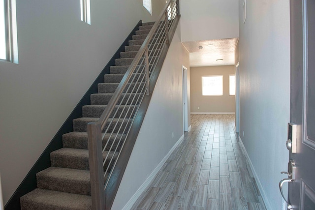 stairs with baseboards and wood finished floors