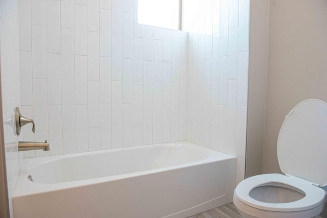 bathroom with a bathing tub and toilet