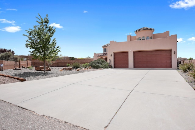 3101 Rachel Ct NE, Rio Rancho, NM 87144 - view of front facade featuring a garage, driveway, stucco siding, fence, and a tiled roof