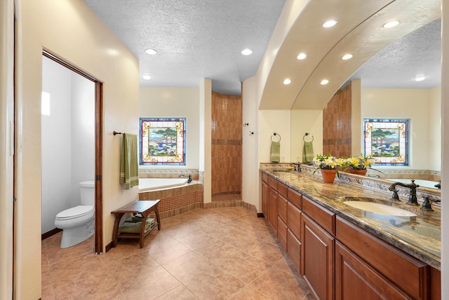 3101 Rachel Ct NE, Rio Rancho, NM 87144 - bathroom with a textured ceiling, recessed lighting, a bath, toilet, and double vanity