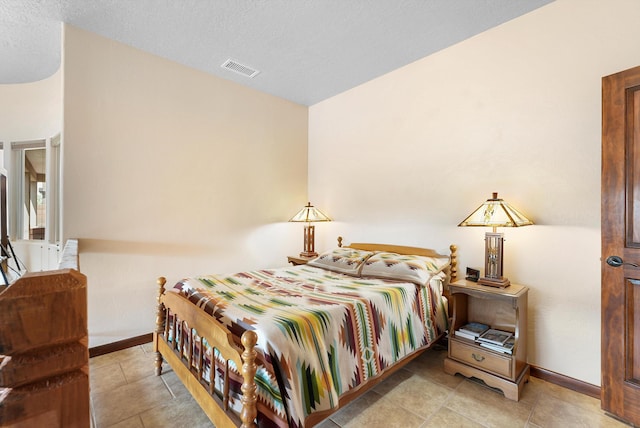 3101 Rachel Ct NE, Rio Rancho, NM 87144 - bedroom with baseboards, light tile patterned floors, and a textured ceiling