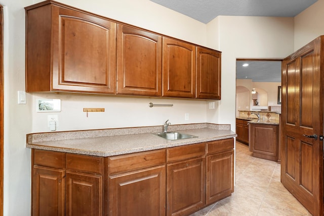 3101 Rachel Ct NE, Rio Rancho, NM 87144 - kitchen featuring a sink, brown cabinetry, and light tile patterned floors