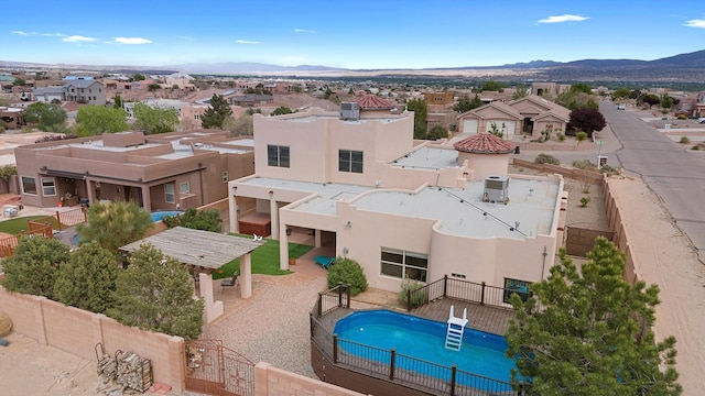 3101 Rachel Ct NE, Rio Rancho, NM 87144 - view of swimming pool with a fenced backyard, a residential view, and a mountain view