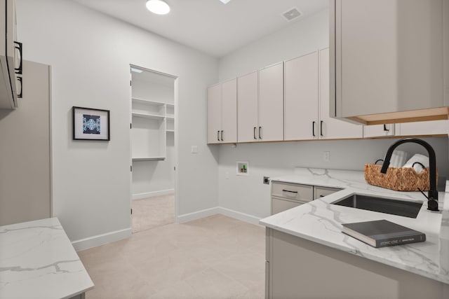1232 21st Ave SE, Rio Rancho, NM 87124 - clothes washing area with visible vents, baseboards, hookup for a washing machine, a sink, and cabinet space