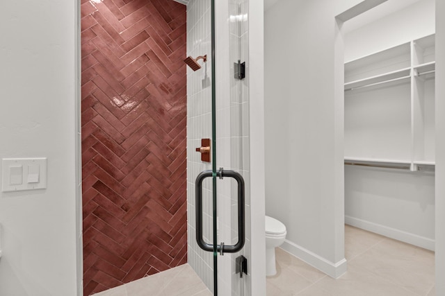 1232 21st Ave SE, Rio Rancho, NM 87124 - bathroom with tile patterned floors, a walk in closet, a stall shower, and toilet