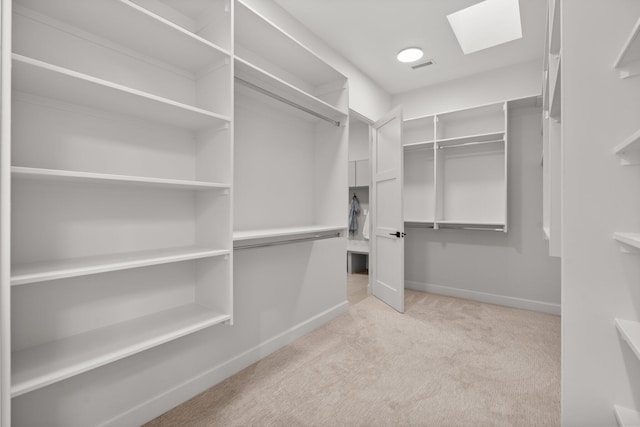 1232 21st Ave SE, Rio Rancho, NM 87124 - walk in closet featuring a skylight, visible vents, and light colored carpet