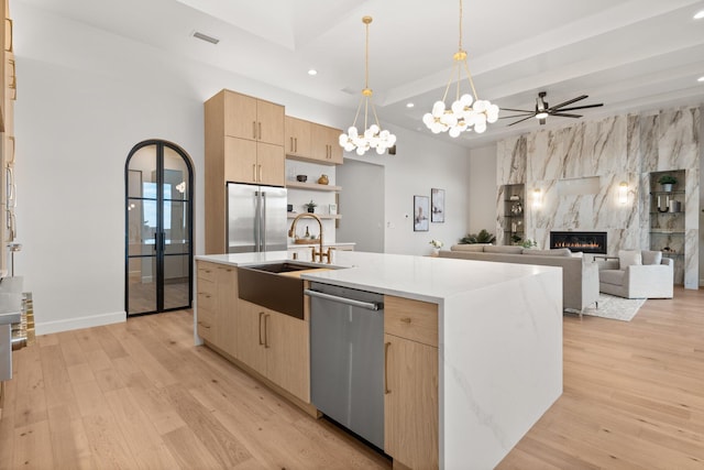 1232 21st Ave SE, Rio Rancho, NM 87124 - kitchen featuring light brown cabinetry, appliances with stainless steel finishes, light wood-type flooring, a sink, and recessed lighting
