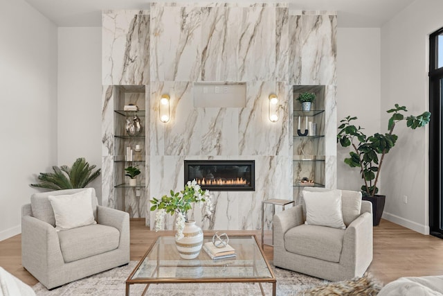 1232 21st Ave SE, Rio Rancho, NM 87124 - living area featuring baseboards, wood finished floors, and a high end fireplace