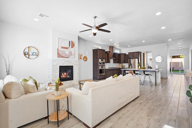 2409 Lynn Rd SE, Rio Rancho, NM 87124 - living area featuring visible vents, recessed lighting, ceiling fan, and a stone fireplace