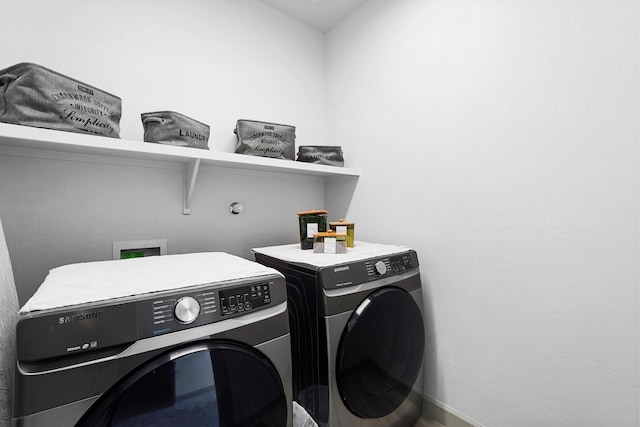 laundry area featuring separate washer and dryer, laundry area, and baseboards