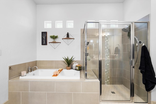 full bath with a shower stall and a garden tub
