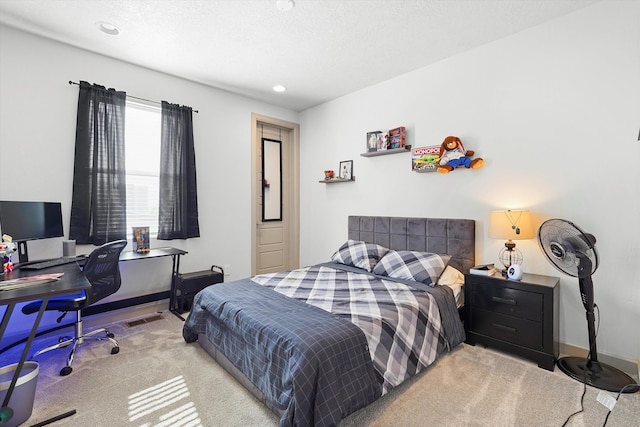 bedroom featuring recessed lighting, a textured ceiling, carpet, and visible vents