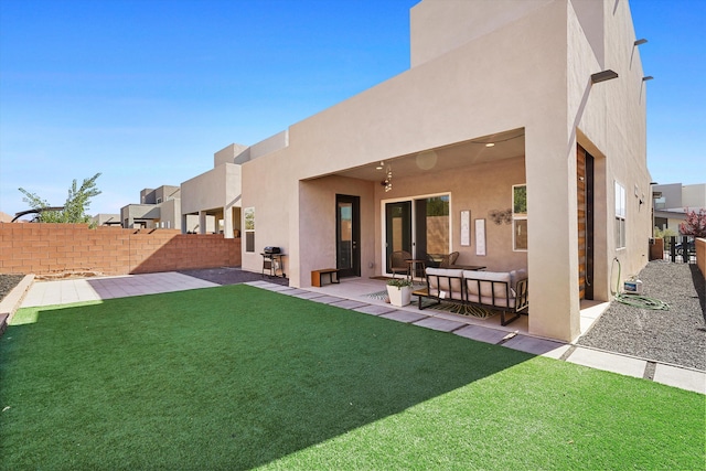 back of property with a lawn, a fenced backyard, a patio area, and stucco siding