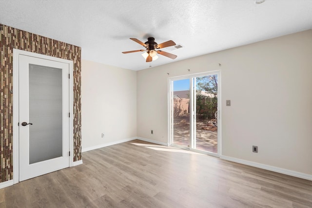 7700 Briar Ridge Ave NW, Albuquerque, NM 87114 - spare room with baseboards, ceiling fan, wood finished floors, and visible vents