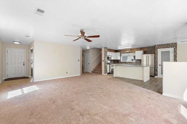 7700 Briar Ridge Ave NW, Albuquerque, NM 87114 - unfurnished living room with baseboards, ceiling fan, and light carpet