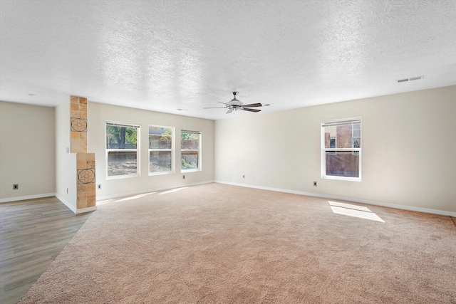 7700 Briar Ridge Ave NW, Albuquerque, NM 87114 - unfurnished living room featuring baseboards, a ceiling fan, a textured ceiling, and visible vents