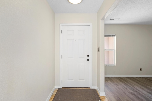7700 Briar Ridge Ave NW, Albuquerque, NM 87114 - doorway featuring baseboards, light wood-style flooring, and visible vents