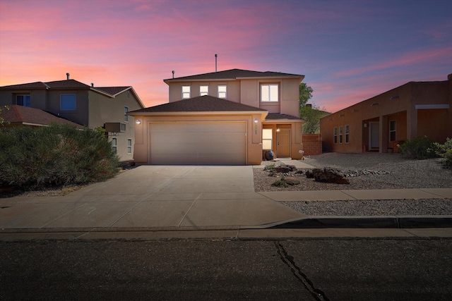 7700 Briar Ridge Ave NW, Albuquerque, NM 87114 - traditional-style home with an attached garage, driveway, and stucco siding