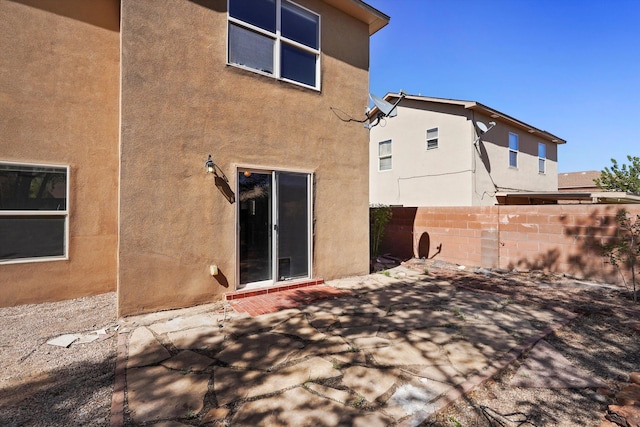 7700 Briar Ridge Ave NW, Albuquerque, NM 87114 - back of house featuring fence, stucco siding, and a patio area