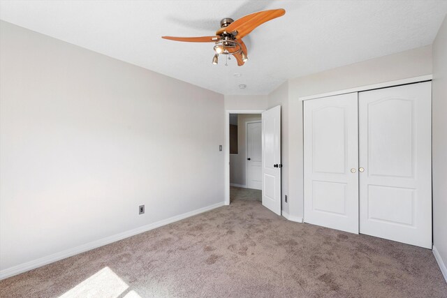 7700 Briar Ridge Ave NW, Albuquerque, NM 87114 - unfurnished bedroom with baseboards, ceiling fan, carpet, and a closet