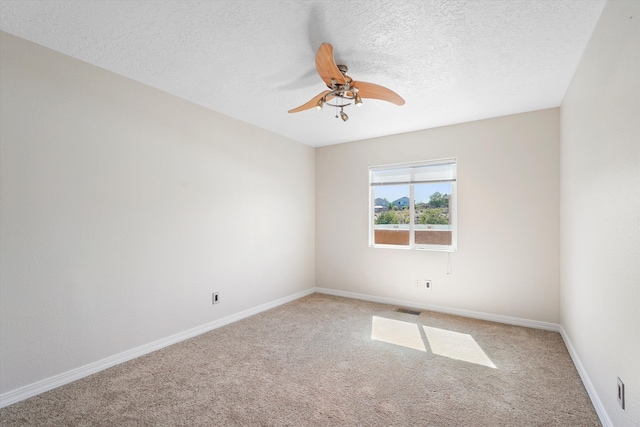 7700 Briar Ridge Ave NW, Albuquerque, NM 87114 - carpeted spare room with visible vents, a textured ceiling, baseboards, and ceiling fan