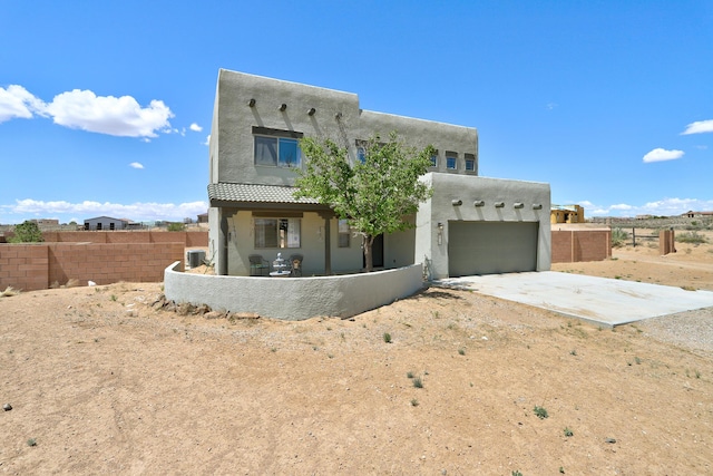 413 Afuste Rd NE, Rio Rancho, NM 87124 - southwest-style home featuring fence, stucco siding, concrete driveway, and a garage