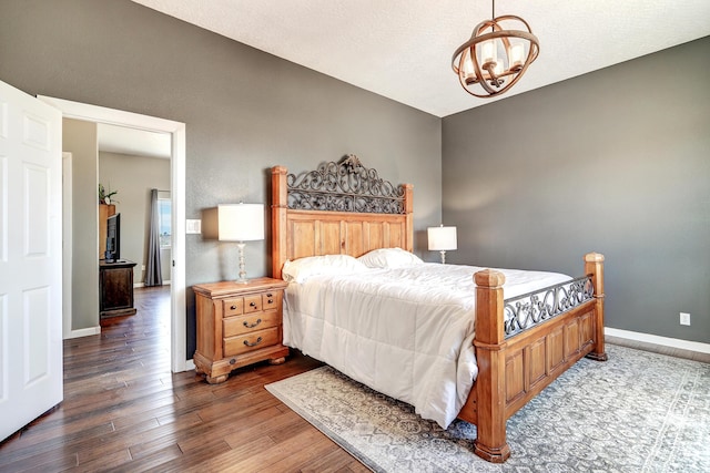 413 Afuste Rd NE, Rio Rancho, NM 87124 - bedroom with baseboards, an inviting chandelier, and wood finished floors