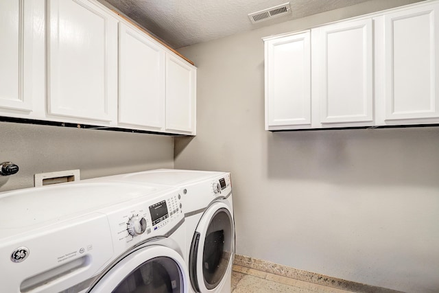 413 Afuste Rd NE, Rio Rancho, NM 87124 - washroom featuring baseboards, visible vents, cabinet space, and washer and clothes dryer