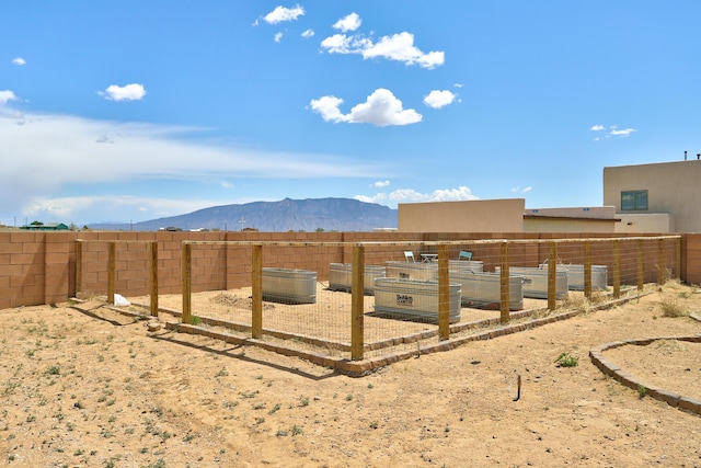 413 Afuste Rd NE, Rio Rancho, NM 87124 - view of yard featuring a mountain view and a fenced backyard