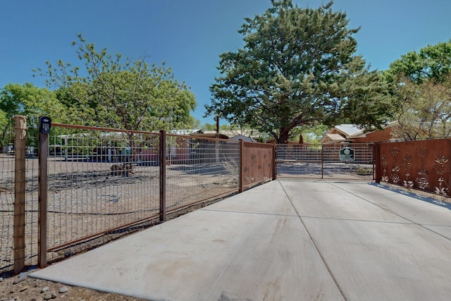 view of gate with a fenced front yard