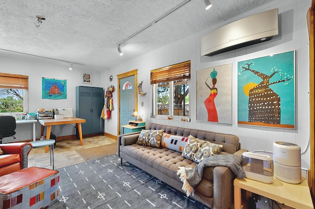 5 Hobbs Rd, Peralta, NM 87042 - living room featuring baseboards, rail lighting, a textured ceiling, and a wall unit AC