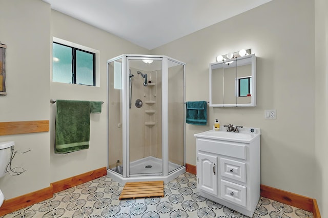 full bathroom featuring vanity, baseboards, and a stall shower