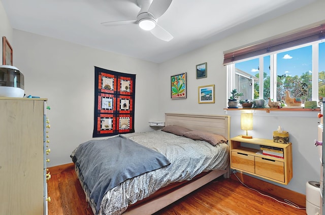 bedroom featuring a ceiling fan and wood finished floors