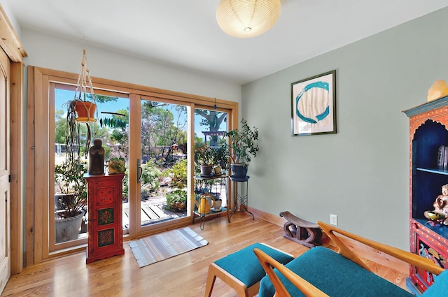 interior space with baseboards and wood finished floors