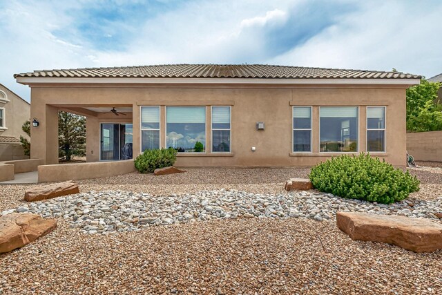 2413 Desert View Rd NE, Rio Rancho, NM 87144 - rear view of house with a ceiling fan and stucco siding