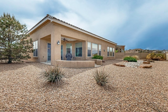 2413 Desert View Rd NE, Rio Rancho, NM 87144 - back of property featuring stucco siding, ceiling fan, fence, and a patio area