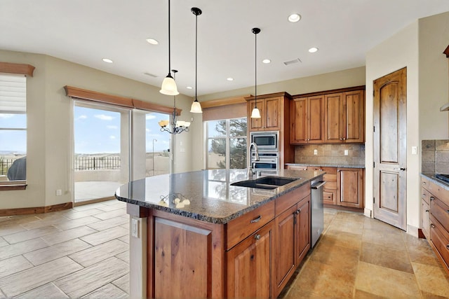 2413 Desert View Rd NE, Rio Rancho, NM 87144 - kitchen with stainless steel appliances, a sink, brown cabinetry, recessed lighting, and decorative backsplash