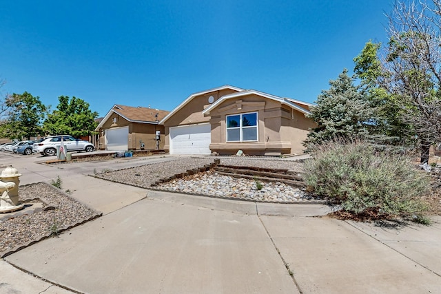 5401 Crown Ridge Rd NW, Albuquerque, NM 87114 - view of front of house with stucco siding, concrete driveway, and an attached garage